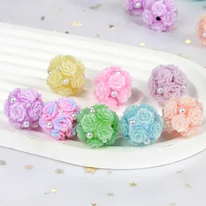 Detailed view of colorful clay rose flower balls with pearls for DIY crafts