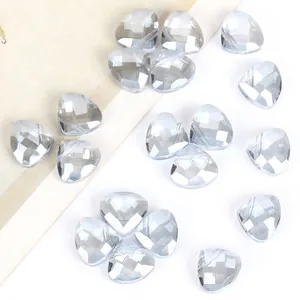 Macro view of faceted triangular crystal beads with side holes for DIY jewelry making.
