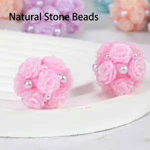 Detailed macro shot of pink clay rose flower ball beads decorated with pearls and glitter