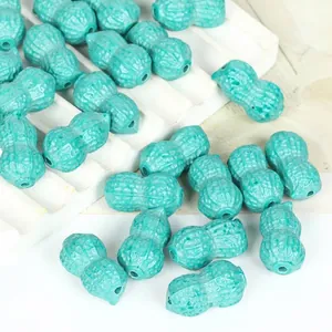 Close-up detail of vibrant turquoise synthetic peanut-shaped loose beads for DIY jewelry making