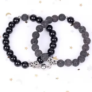 Macro detail of magnetic attraction bracelets featuring black onyx and porous lava stone beads