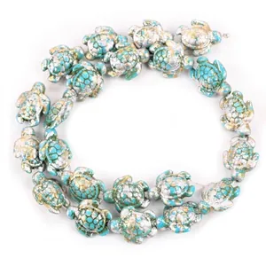 Detailed view of turtle-shaped turquoise beads with gold accents for DIY jewelry