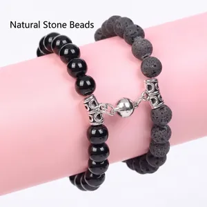 Detailed view of magnetic heart clasp connecting lava stone and polished obsidian bead bracelets