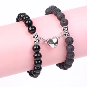 Detail view of magnetic heart clasp on black obsidian and lava stone bead bracelets