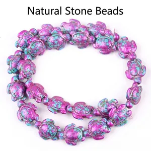 Detailed view of synthetic turquoise turtle beads with vibrant purple and blue marbling