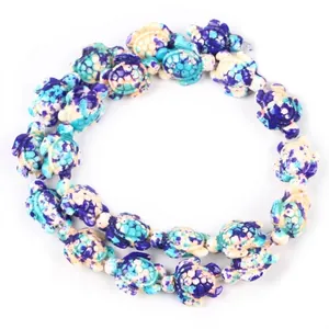 Detailed view of synthetic turquoise turtle-shaped beads for DIY jewelry making