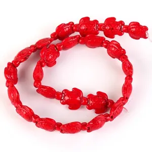 Detailed view of vibrant red synthetic turquoise beads in a charming sea turtle shape.