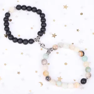 Elegant magnetic couple bracelets featuring matte black beads and natural colorful stones.