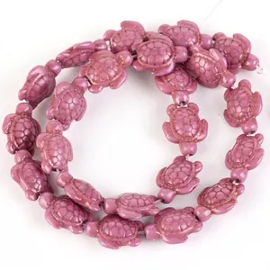 Detailed view of purple synthetic turquoise turtle-shaped loose beads for DIY jewelry