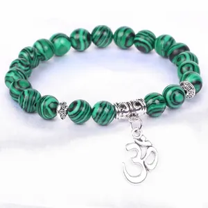 Green malachite-style beaded bracelet featuring a silver Om symbol charm for meditation