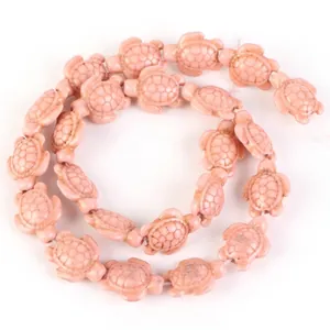 Detailed close-up of pink synthetic turquoise turtle-shaped beads for DIY jewelry making