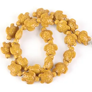 Detailed macro shot of yellow synthetic turquoise turtle beads for DIY jewelry making