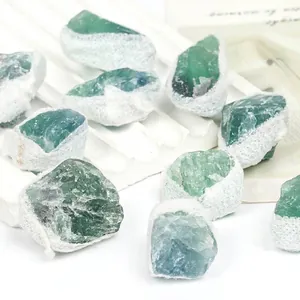 Detailed macro view of raw natural green fluorite mineral specimens in white mesh