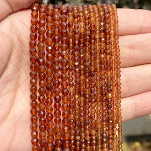 Detailed view of faceted brownish-red natural stone beads used for DIY jewelry making.