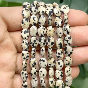 Close-up of 6x8mm faceted flat oval Dalmatian stone loose beads for DIY jewelry