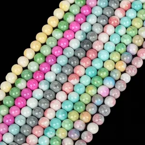Close-up of colorful round glass beads with marbleized crackle patterns for DIY jewelry