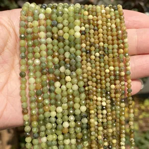Detailed view of faceted olive green natural stone beads showing texture and cut