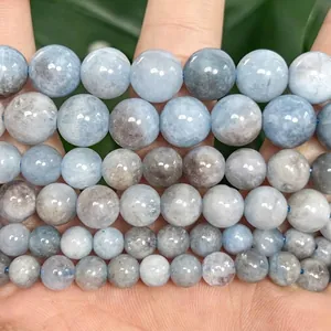 Macro detail of natural light blue aquamarine stone beads with a smooth polished finish.