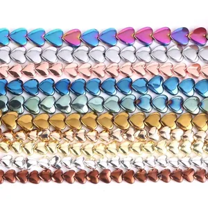 Detailed view of various colorful electroplated heart-shaped hematite beads for DIY jewelry.