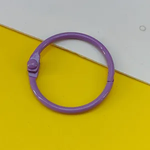 Macro detail of a 30mm purple painted metal binder ring for DIY crafts and binding.