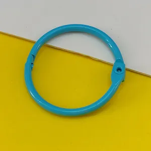 Detailed macro view of a 30mm candy blue painted metal binder ring for DIY crafts.
