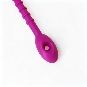 Close-up of a purple silicone cable tie showing the round eyelet hole and ribbed texture.