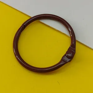 Close-up of a 30mm brown painted metal loose-leaf binder ring for DIY jewelry crafts