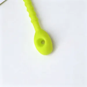 Close-up detail of a 21cm thick neon green flexible silicone cable tie for DIY use