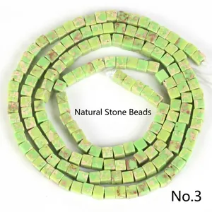 Close-up of 2x2mm green square imperial jasper spacer beads with natural texture