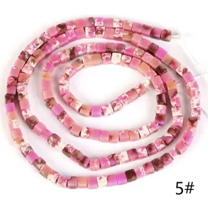Close-up detail of 2x2mm pink square natural stone beads for jewelry making.