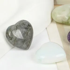 Macro detail of heart-shaped natural labradorite stone with horizontal hole for DIY