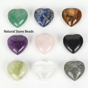 Detailed view of nine colorful heart-shaped natural stone beads for DIY jewelry making
