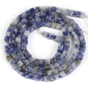 Macro view of 2x2mm natural stone square spacer beads with blue marble texture