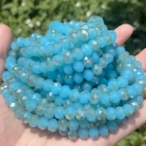 Macro view of faceted lake blue glass beads showing high-shine texture for jewelry DIY