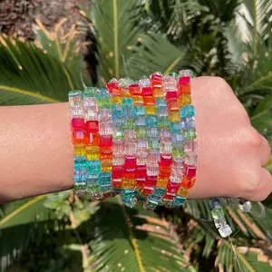 Macro shot of vibrant rainbow square crystal glass beads used for DIY bracelet making