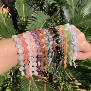 A close-up detail view of colorful faceted heart-shaped natural stone beads for jewelry.