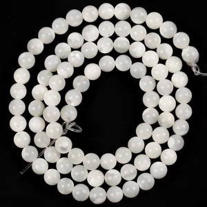 Close-up of natural white Trochus shell loose beads with pearlescent luster for DIY jewelry