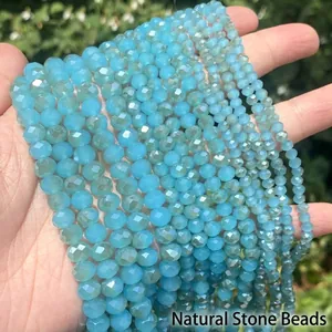 Close-up of faceted lake blue crystal glass beads in various sizes for DIY jewelry.