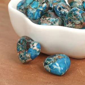 Macro view of blue heart-shaped imperial turquoise beads with unique natural patterns.