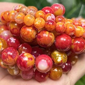 Macro detail of natural orange and red dragon vein fire agate round beads for DIY jewelry