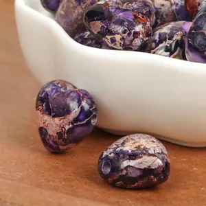Close-up detail of 15mm heart-shaped purple Imperial Turquoise beads for DIY jewelry