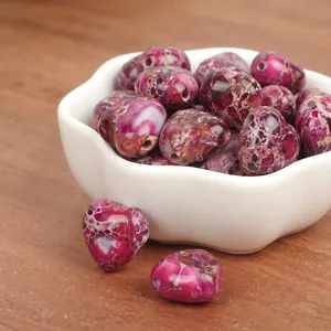 Close-up detail of 15mm heart-shaped imperial jasper stone beads for DIY jewelry