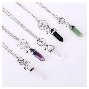 Detailed view of natural crystal point necklaces with various silver-colored charms