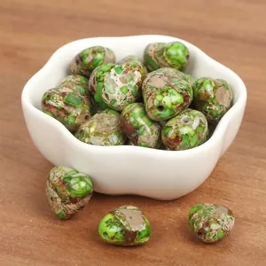 Macro detail of heart-shaped green imperial turquoise stone beads for jewelry making