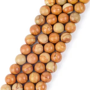 Detailed macro view of natural yellow stone round beads with marbled texture for jewelry