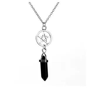 Detailed close-up of a silver pentagram necklace with a black agate crystal point