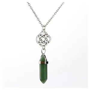 Macro detail of natural green aventurine hexagonal point pendant with Celtic knot ornament