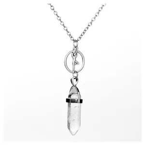 Close-up of silver yoga pose pendant with clear white crystal hexagonal point charm.