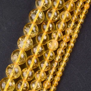 Macro detail of yellow natural stone beads with various sizes for jewelry making