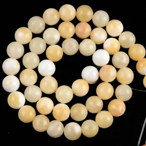 Macro view of polished yellow natural stone round beads for DIY jewelry making crafts